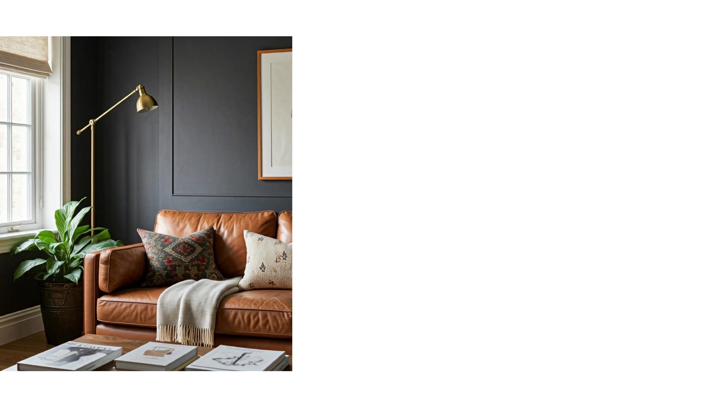 A warm corner lounge with a tan leather sofa, dark walls and layered textures.